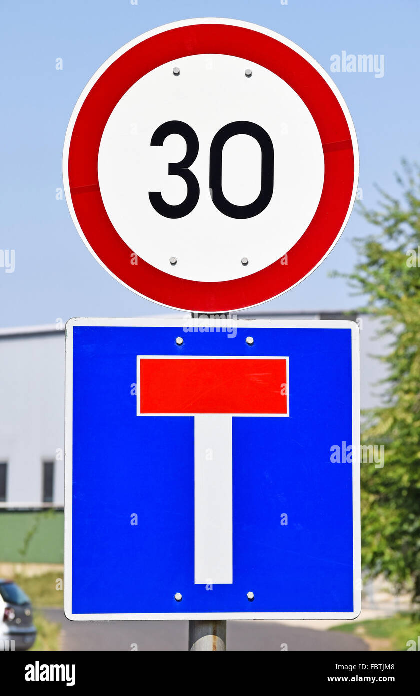 Speed limit and dead end traffic signs on the road Stock Photo