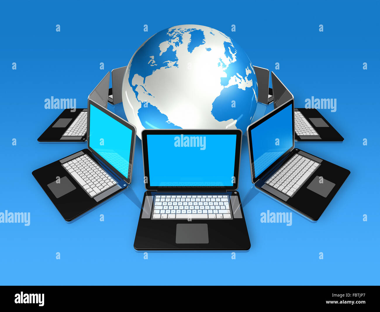 Laptop computers around a world globe Stock Photo - Alamy