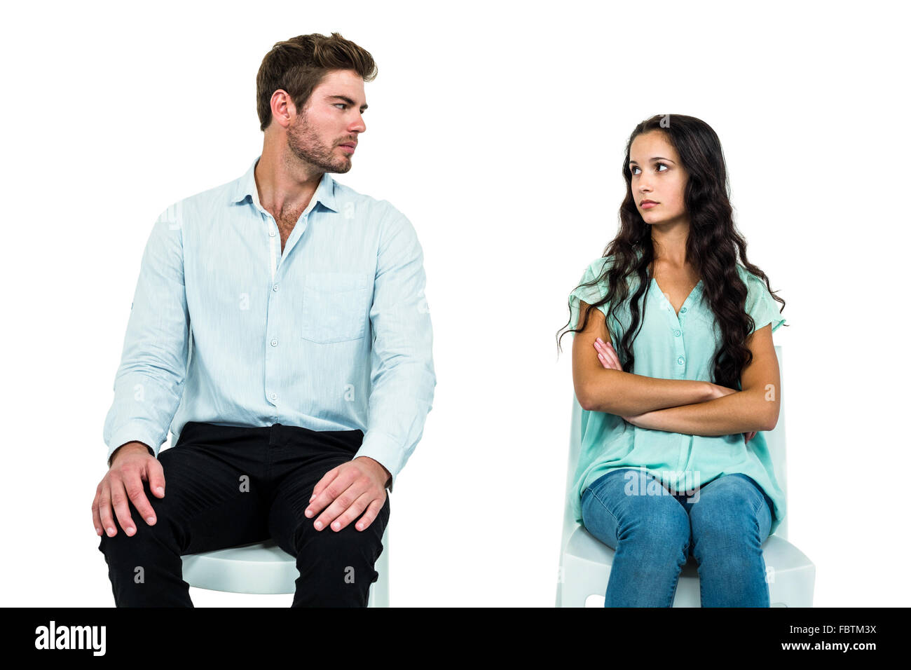 Couple sitting on chairs not talking after argument Stock Photo - Alamy