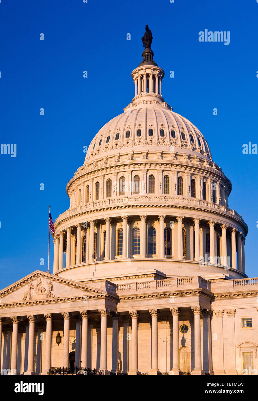Rising sun illuminates the front of the Capitol building in DC Stock