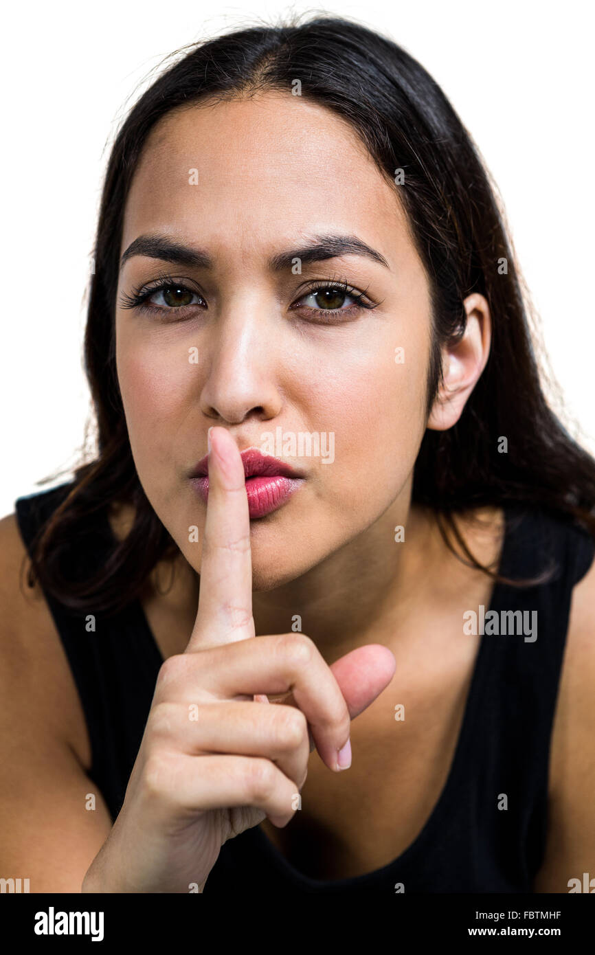Young woman with finger on lips Stock Photo