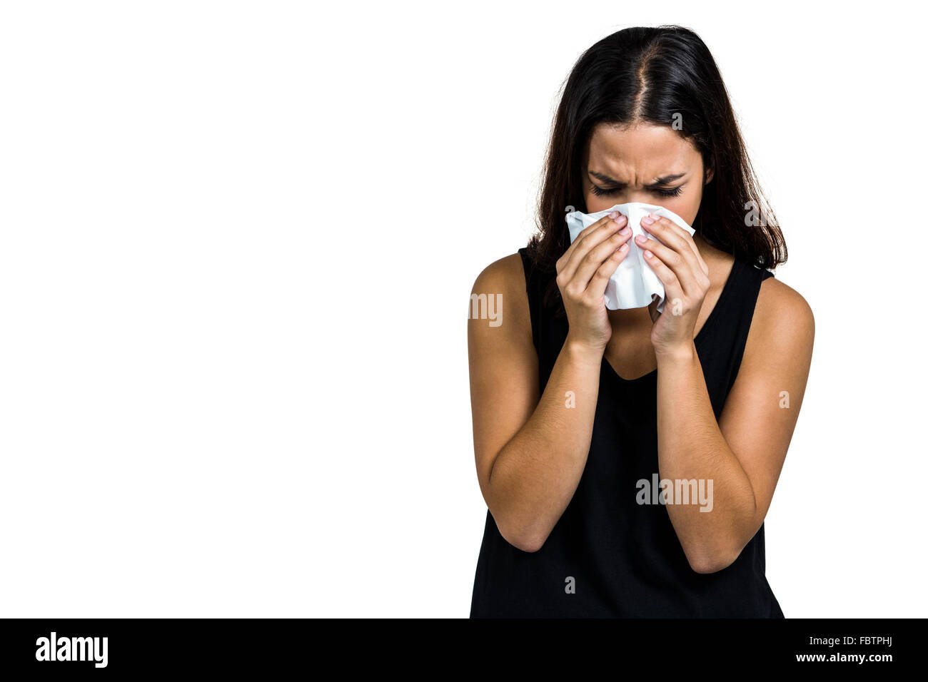 Unhappy woman blowing nose Stock Photo