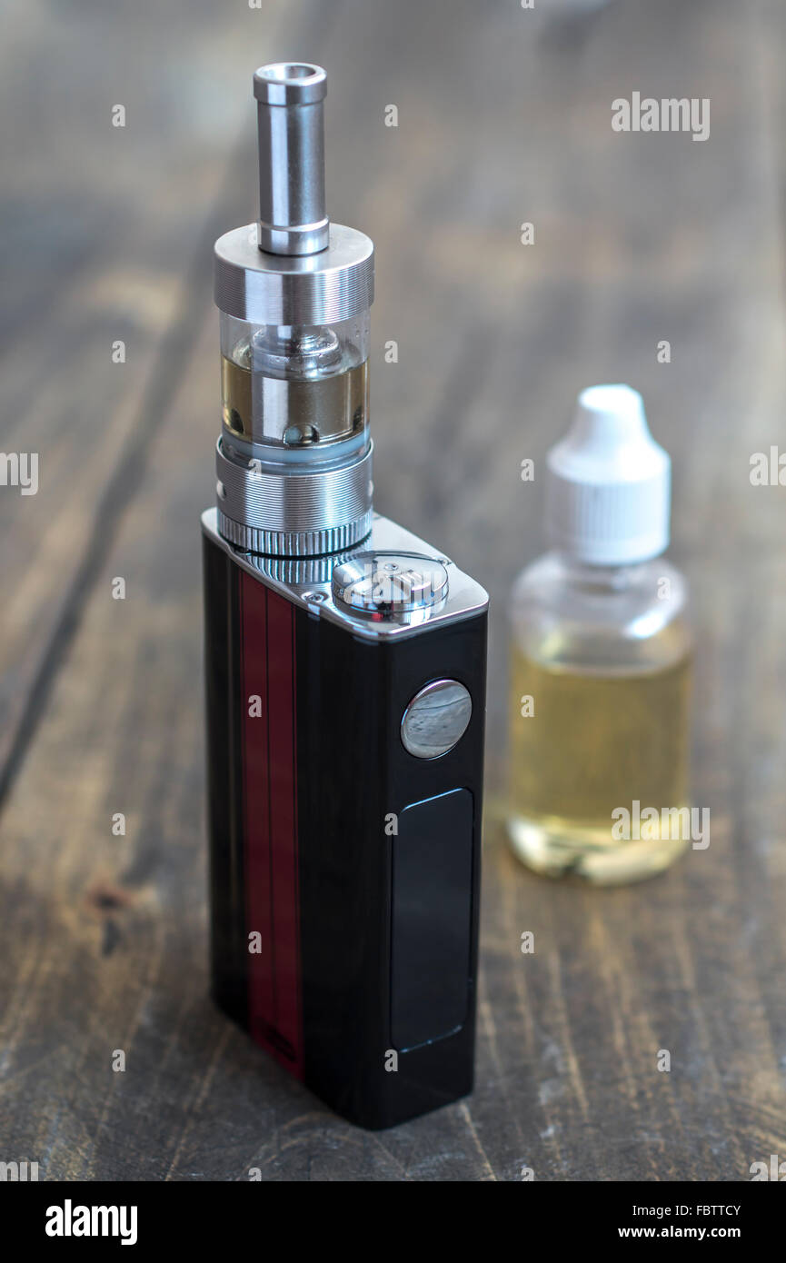 E-cigarette or vaping device on wooden surface, natural light Stock Photo