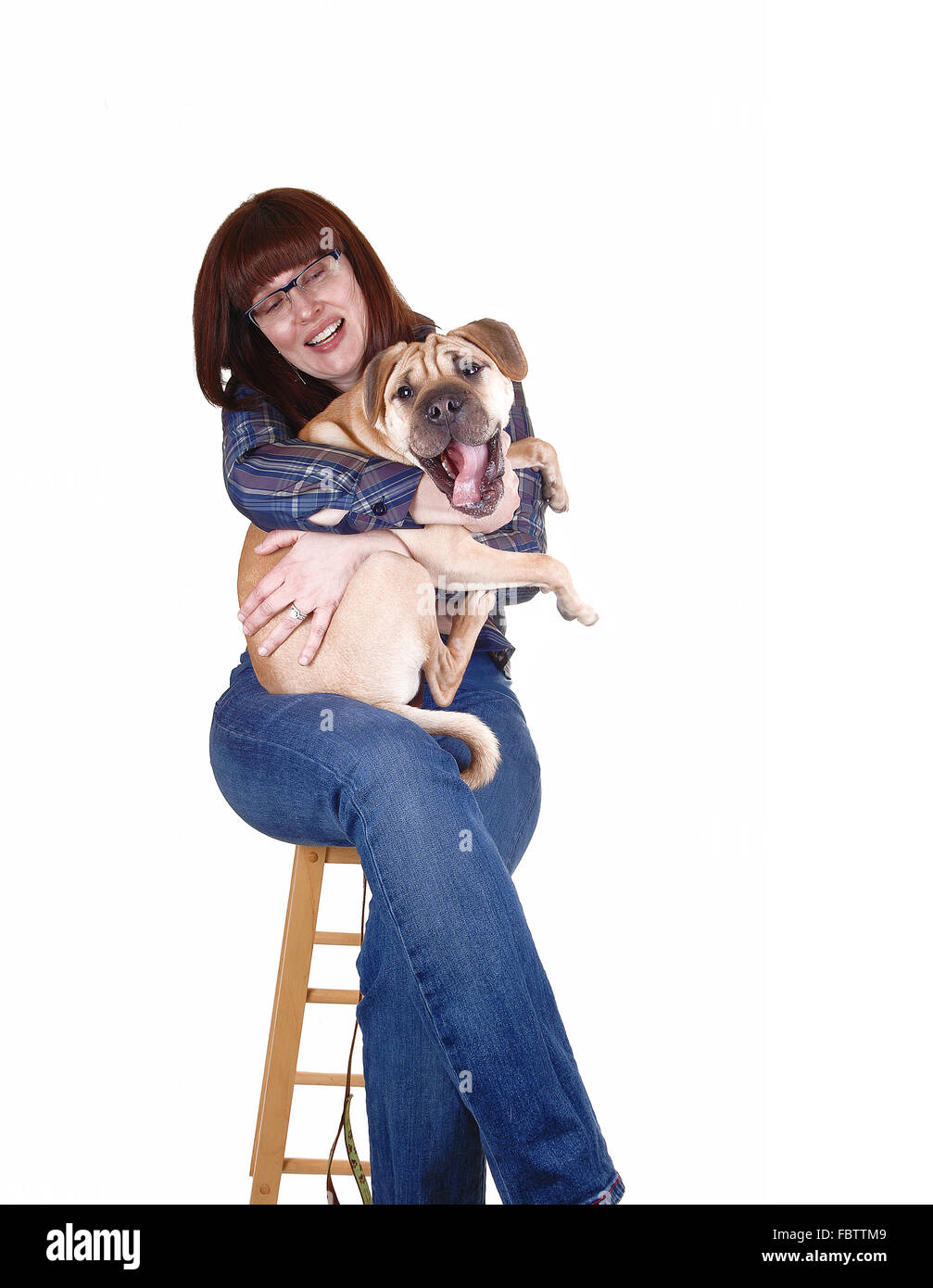 Woman holding dog. Stock Photo