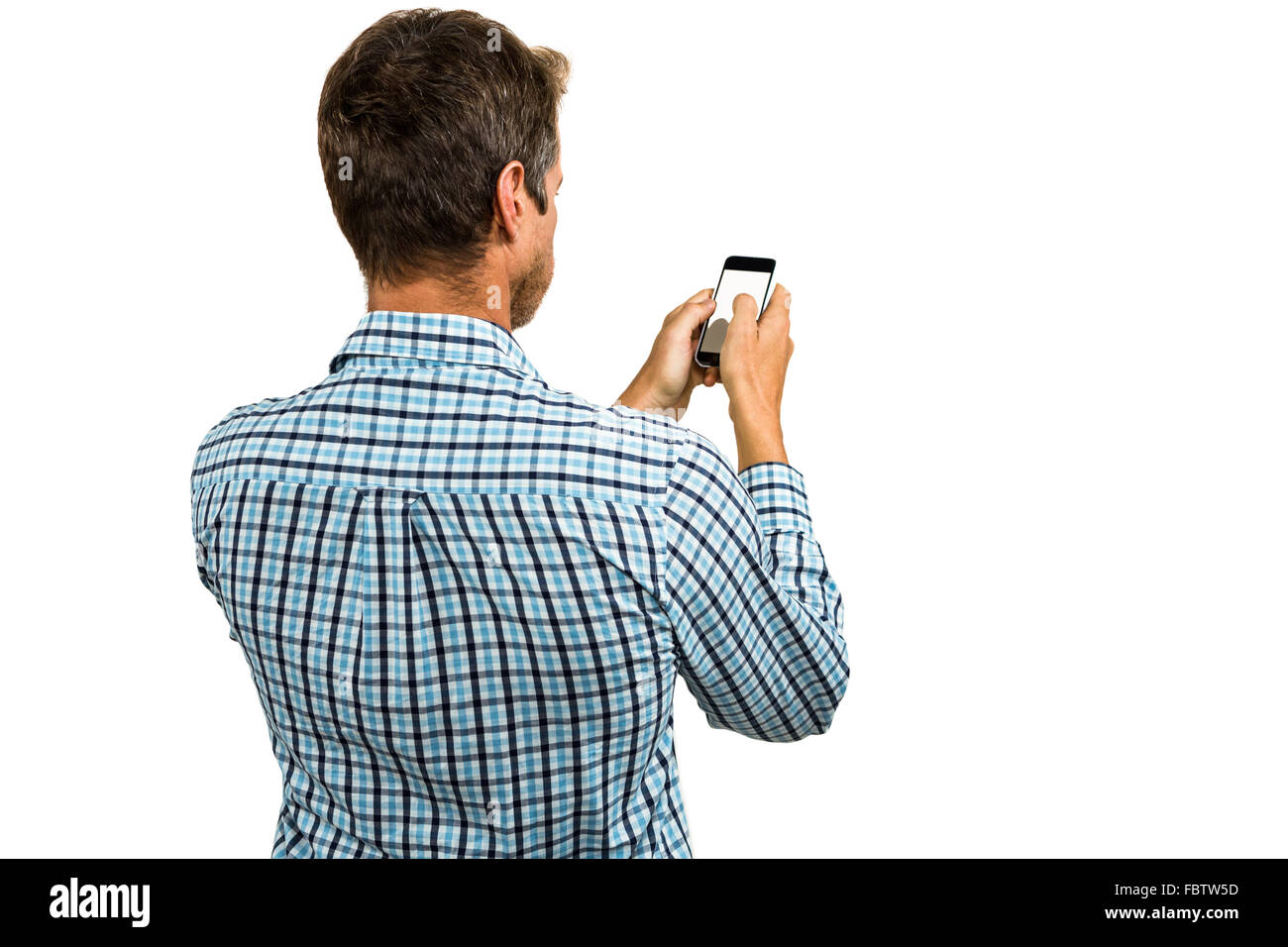 Rear view of man using smartphone Stock Photo