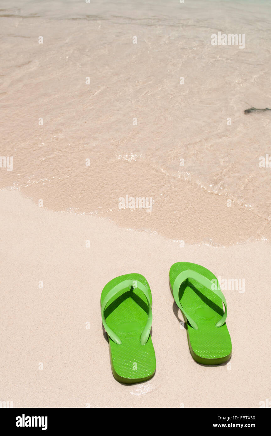 Flip flops on the beach Stock Photo - Alamy