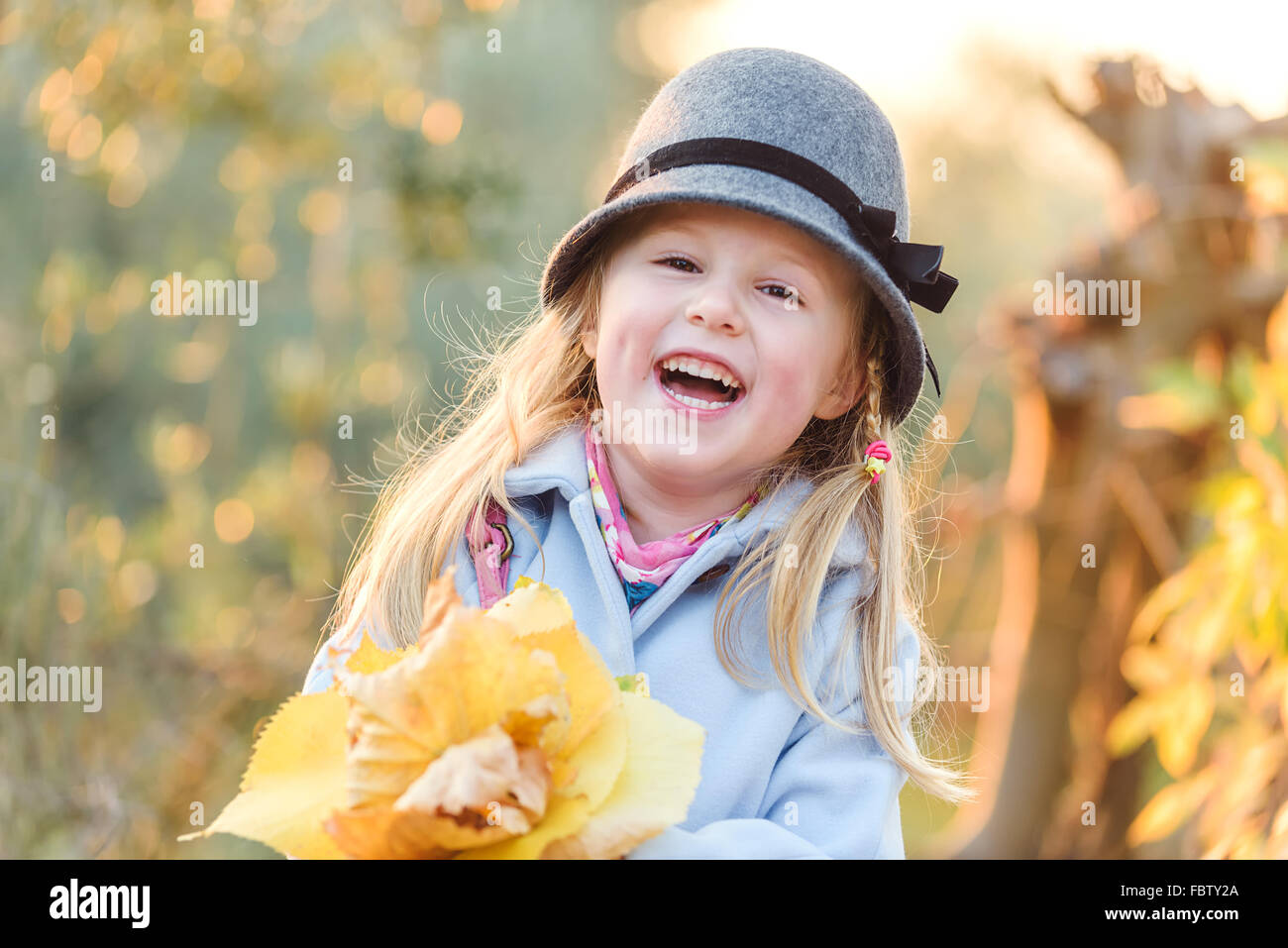 Young smiling girl in autumn day Stock Photo - Alamy