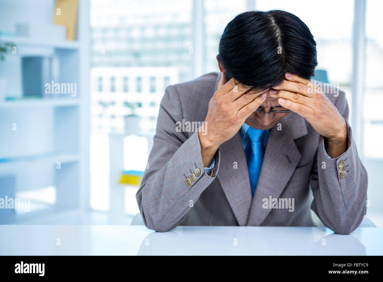 Worried businessman at his desk Stock Photo - Alamy