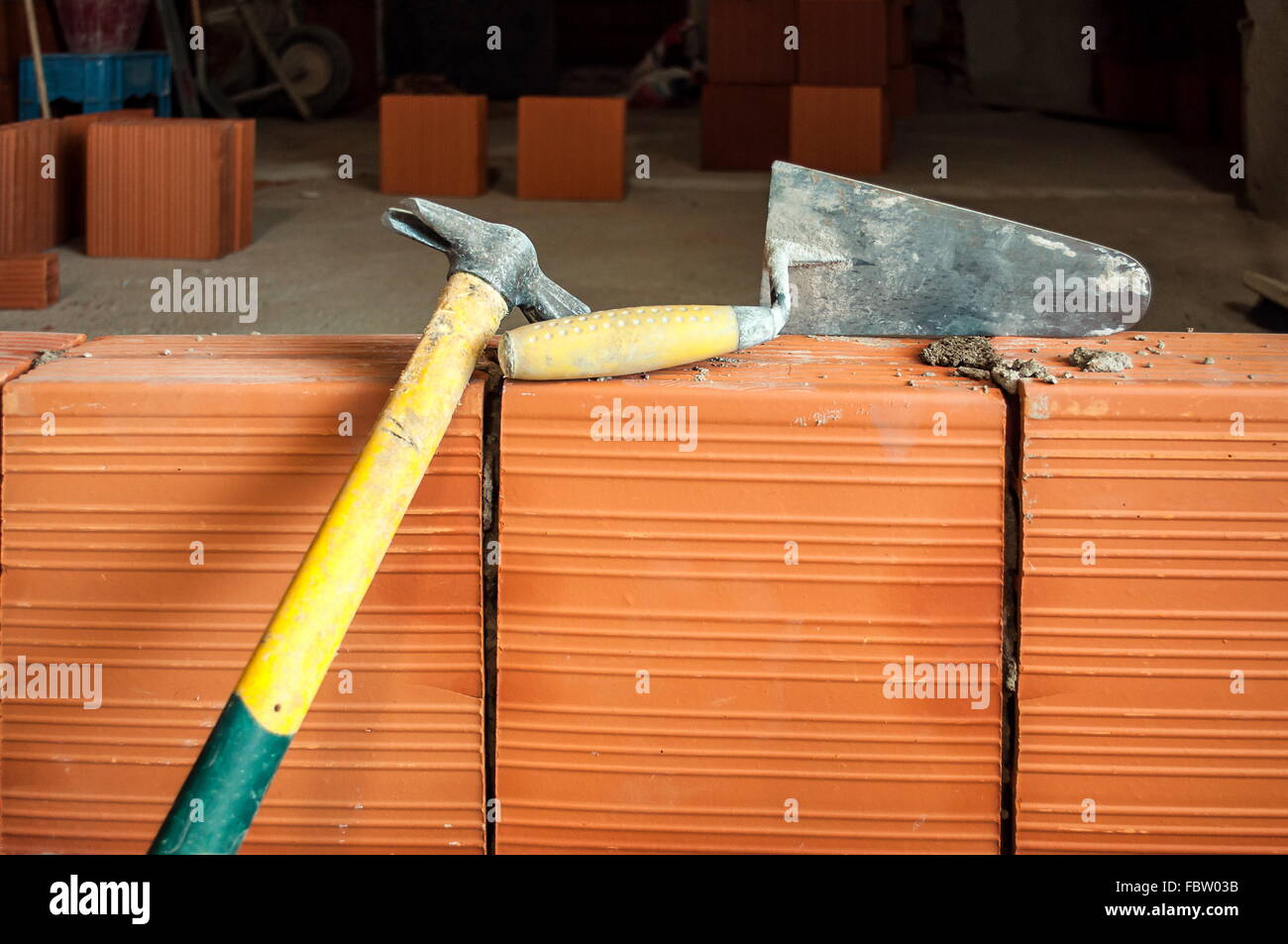 Hammer and trowel on construction site Stock Photo Alamy