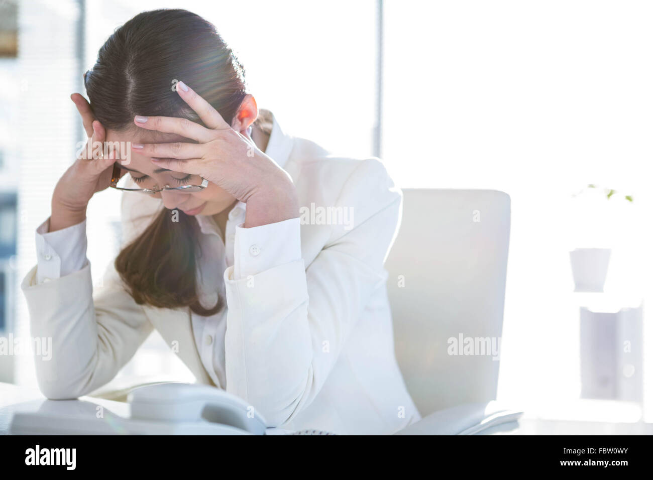 Stressed businesswoman working at her desk Stock Photo - Alamy