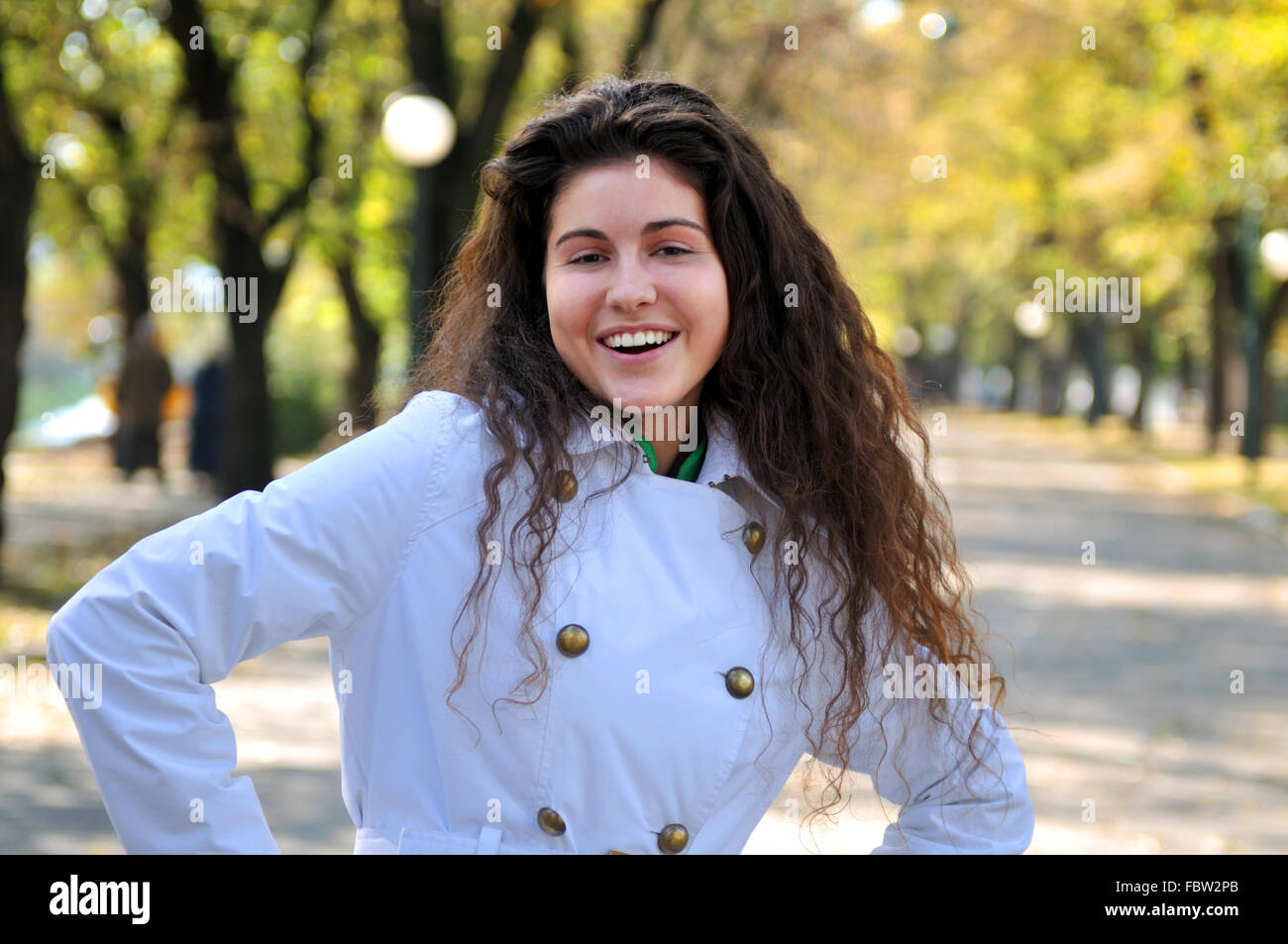 brunette Cute young woman smiling outdoors in nature Stock Photo - Alamy