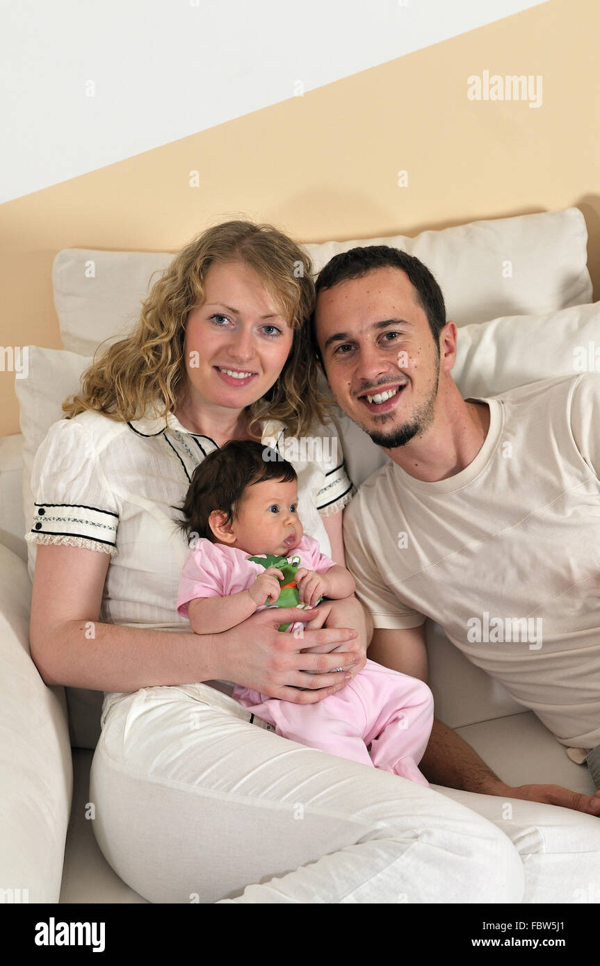 indoor portrait with happy young family and cute little babby Stock ...