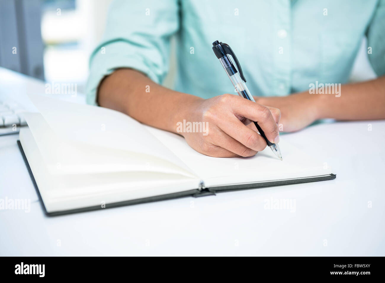 Close up view of a businesswoman writing notes Stock Photo - Alamy