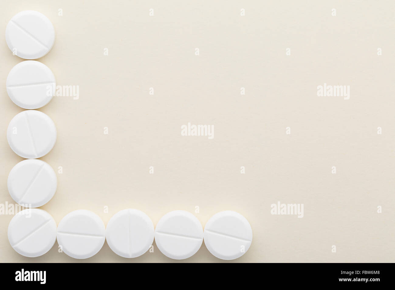 Bright background with white pills Stock Photo