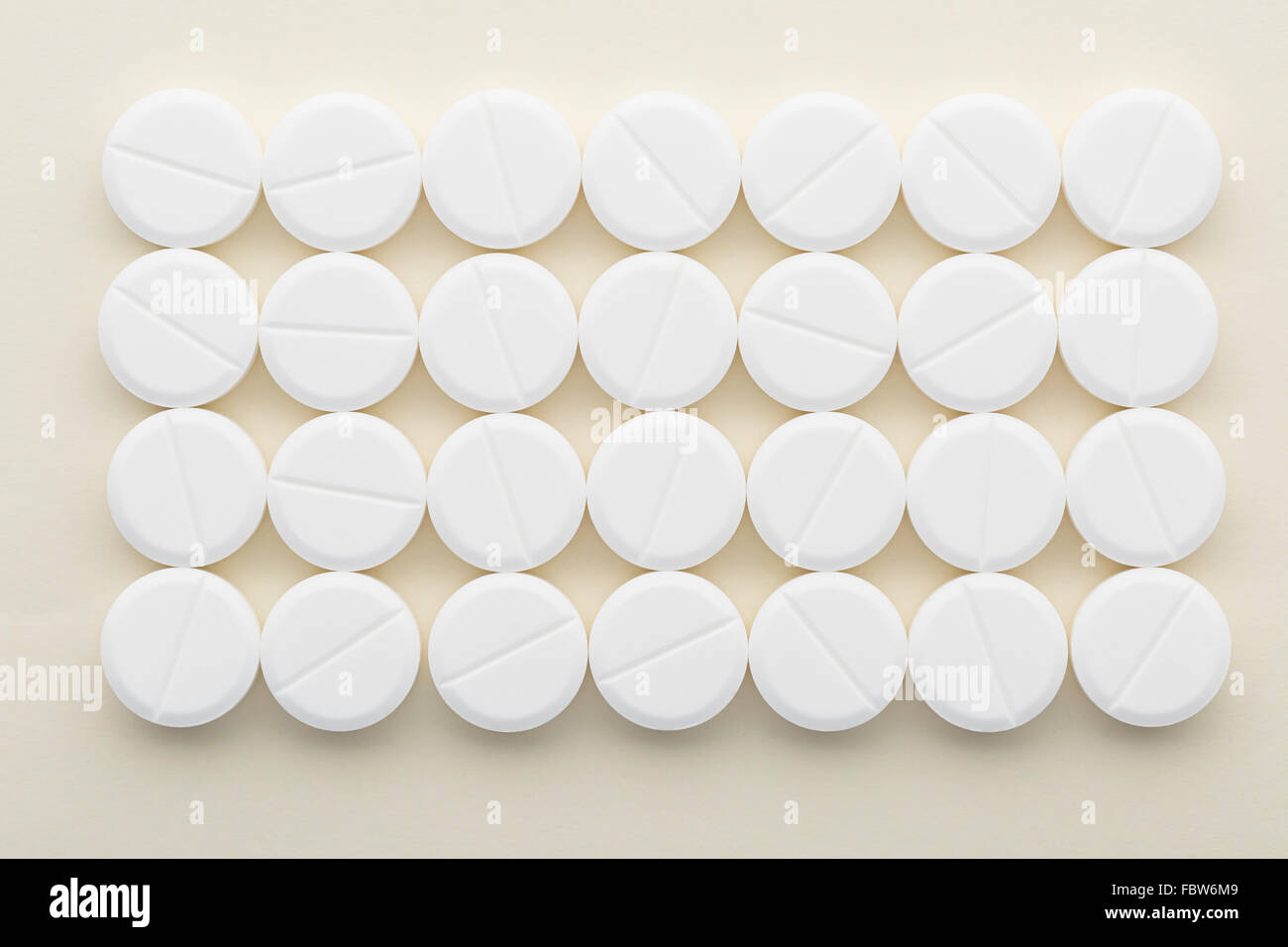Rectangle of white pills on a light background Stock Photo