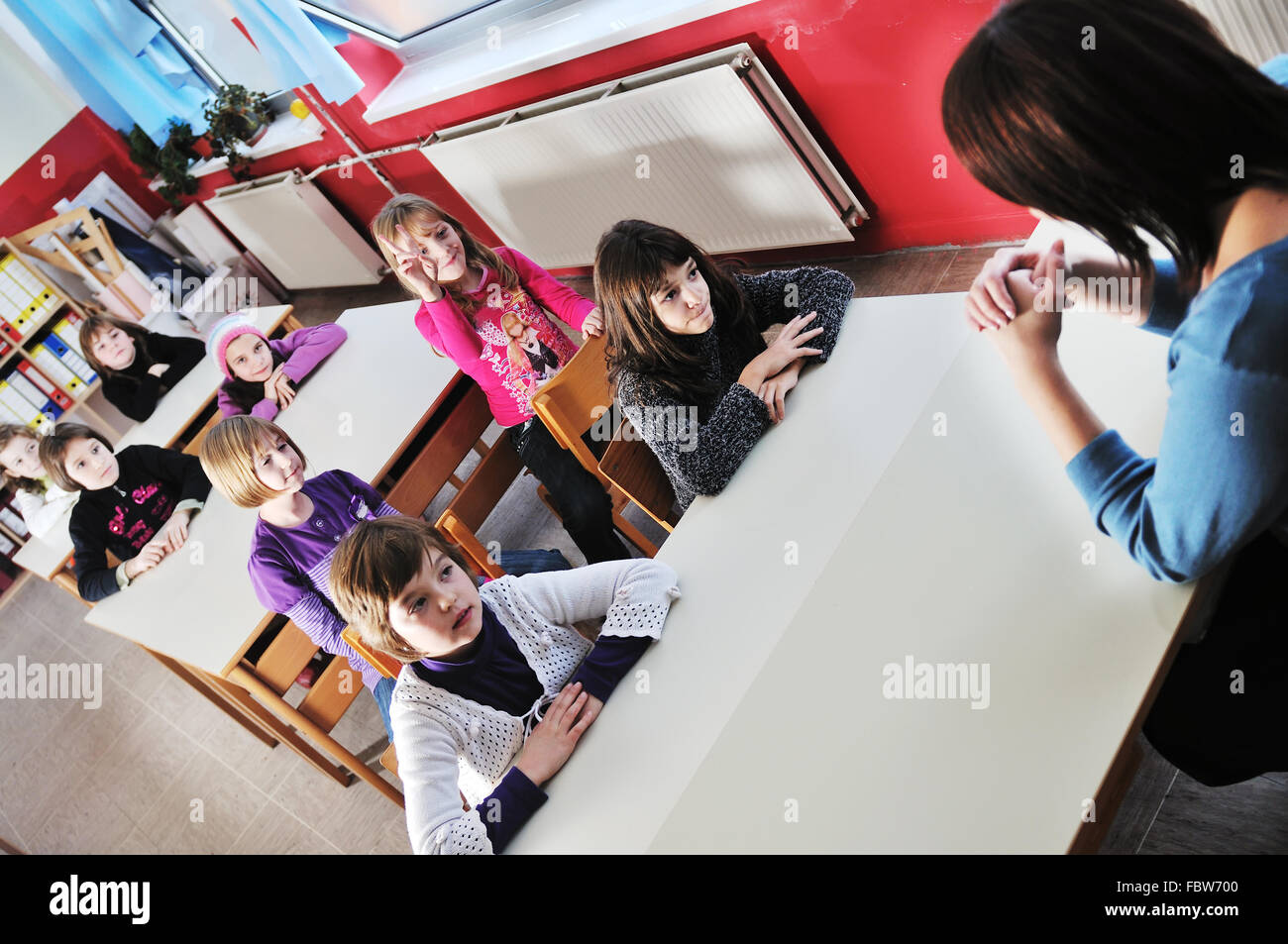 happy kids with teacher in school classroom Stock Photo - Alamy