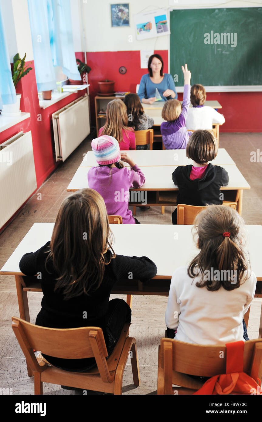 happy kids with teacher in school classroom Stock Photo - Alamy