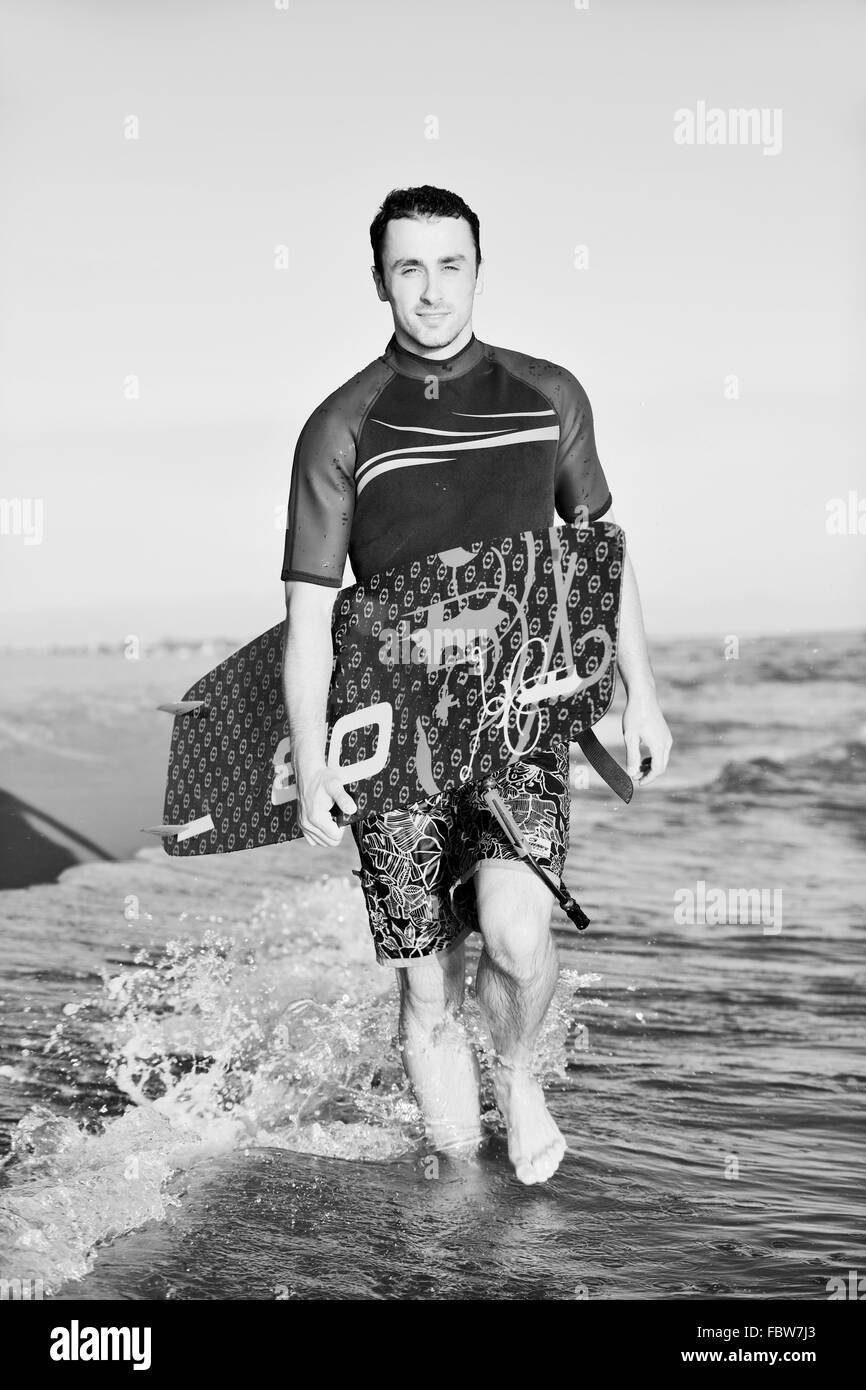 Portrait of a young  kitsurf  man at beach on sunset Stock Photo