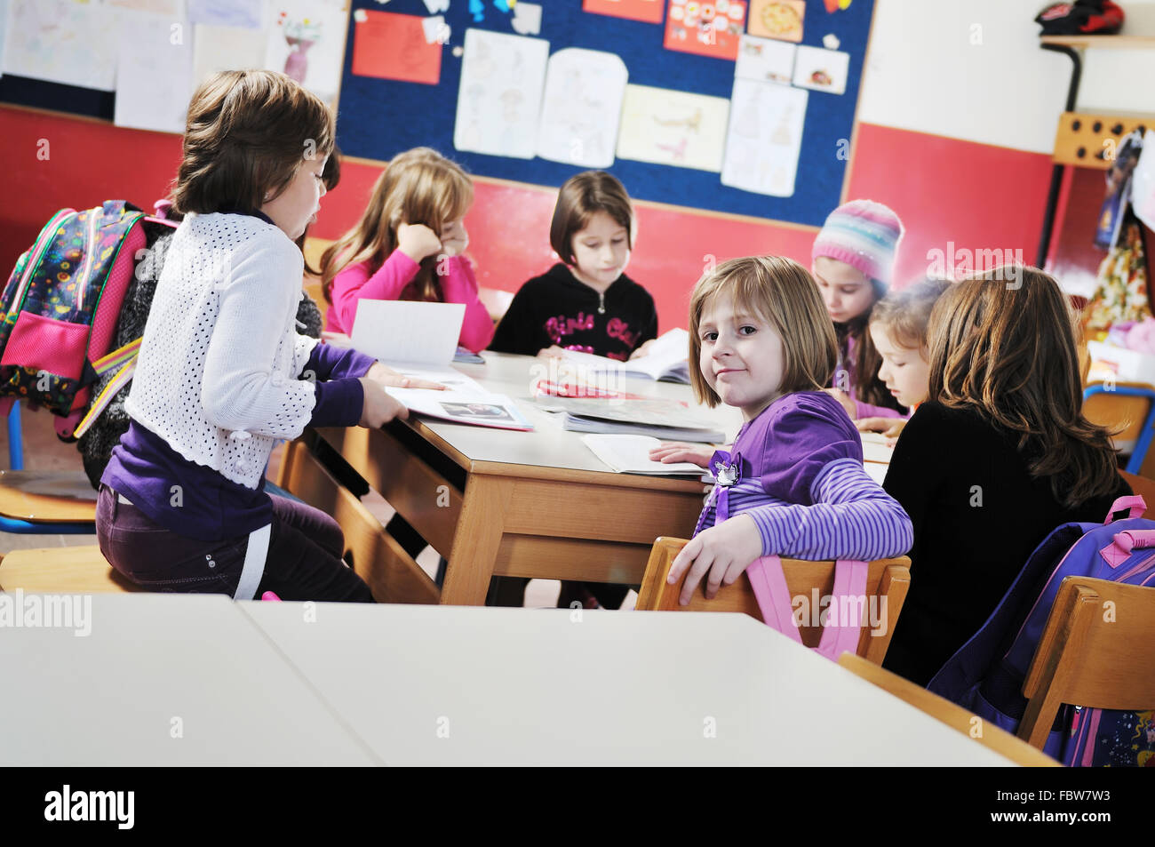 happy kids with teacher in school classroom Stock Photo - Alamy