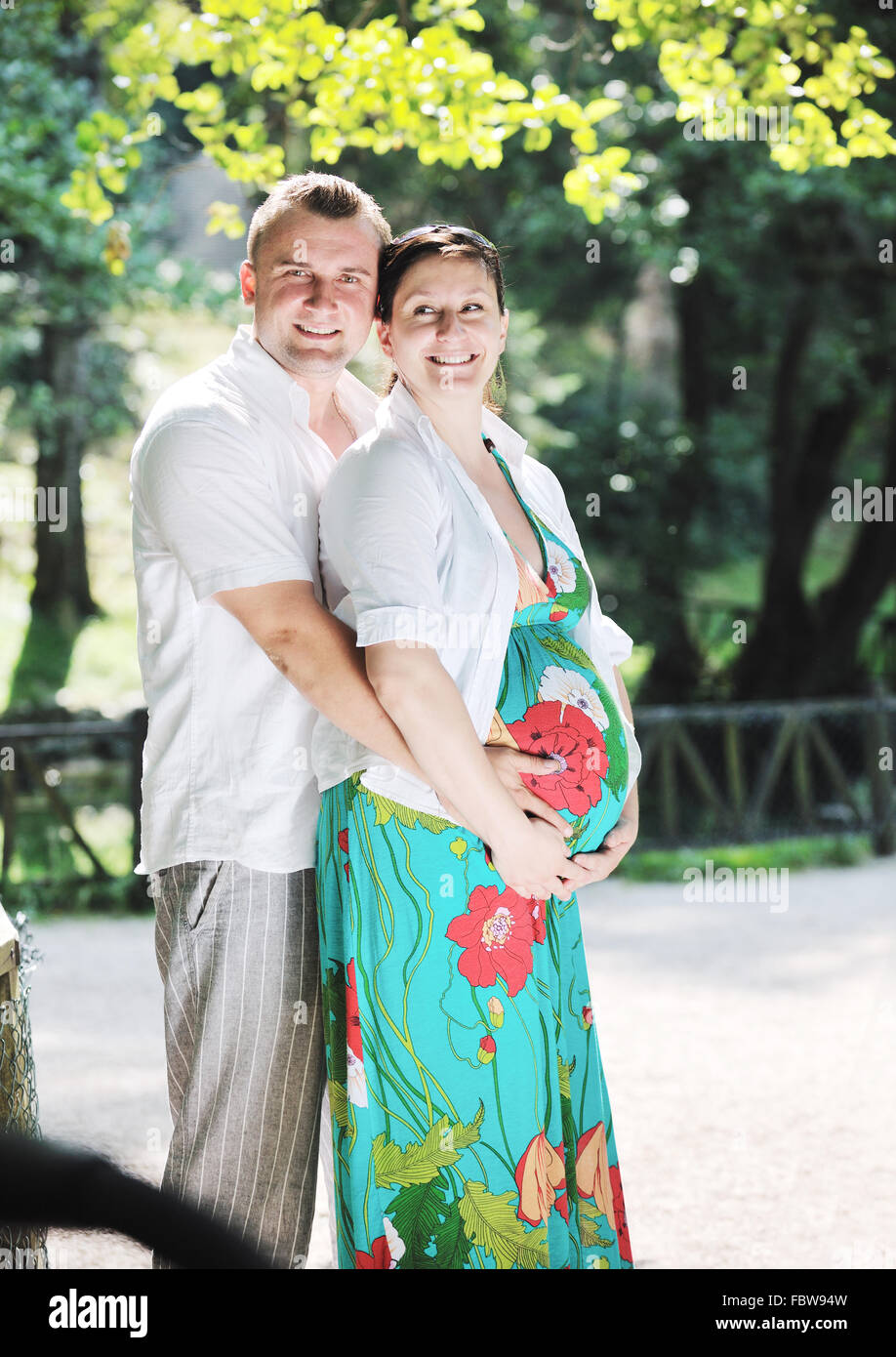 Happy pregnant couple at beautiful sunny day in park Stock Photo - Alamy