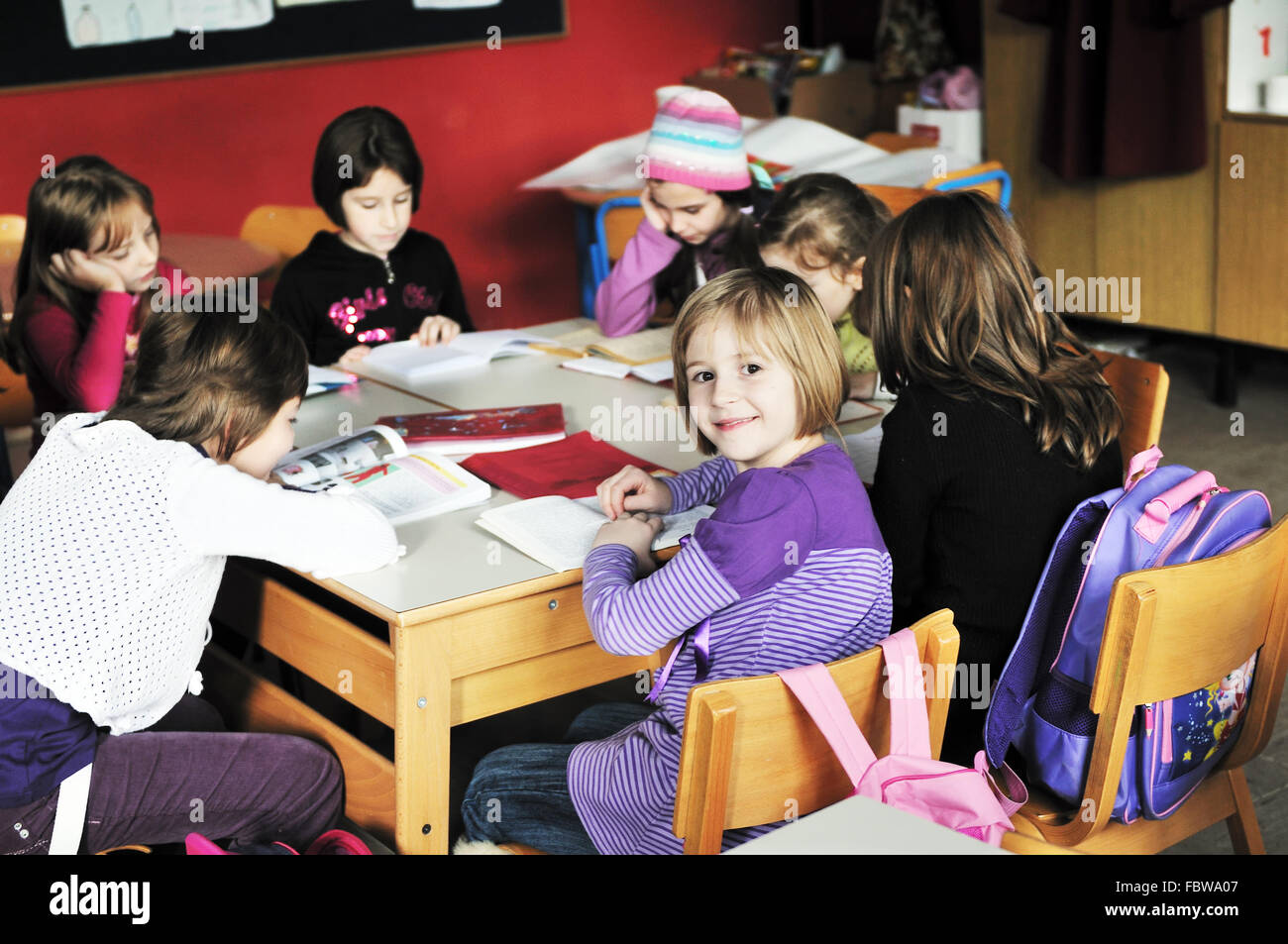happy kids with teacher in school classroom Stock Photo - Alamy