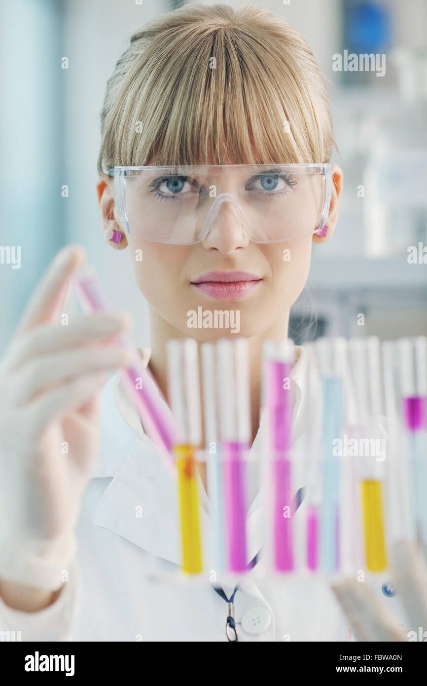 female researcher holding up a test tube in lab Stock Photo Alamy