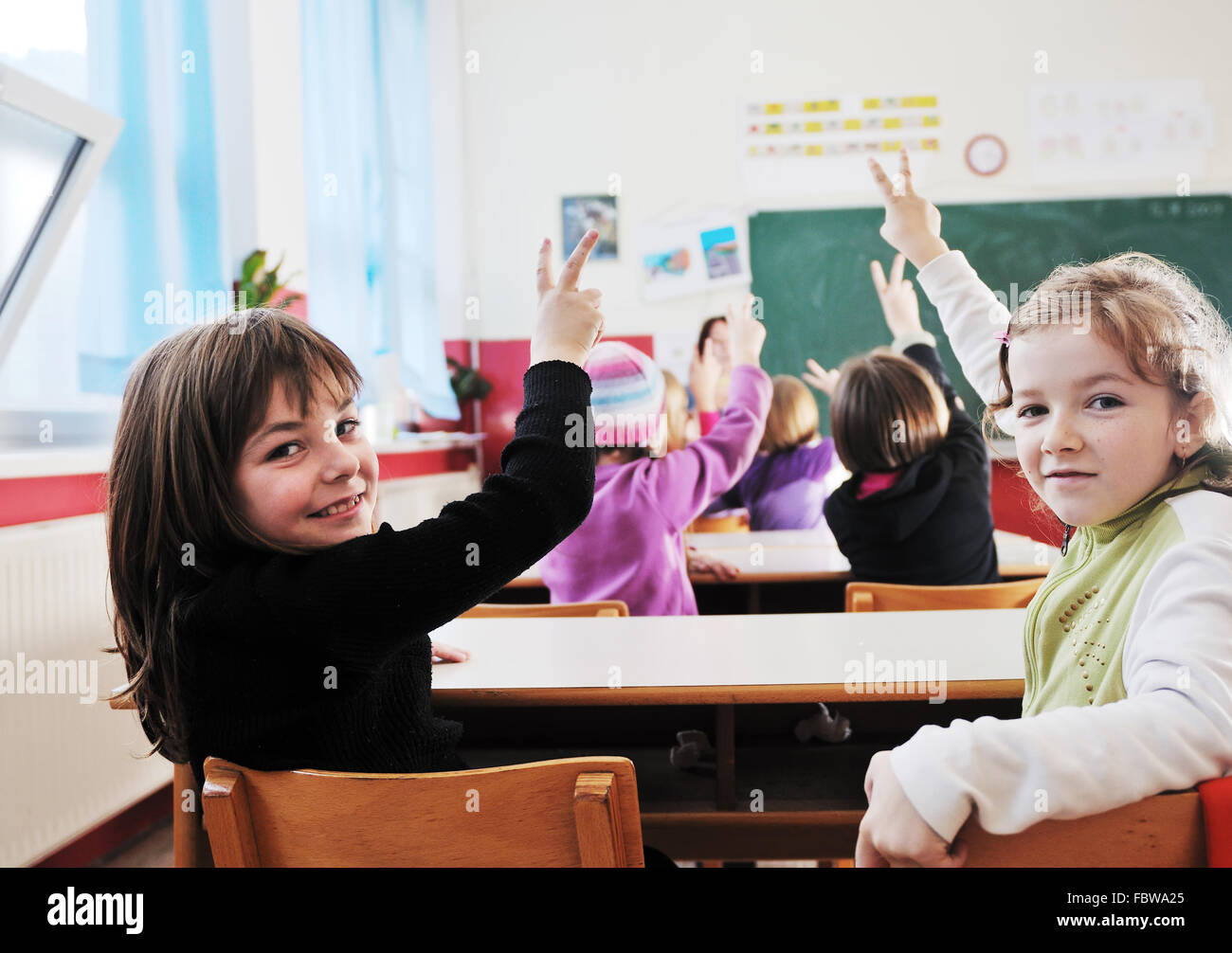 happy kids with teacher in school classroom Stock Photo - Alamy