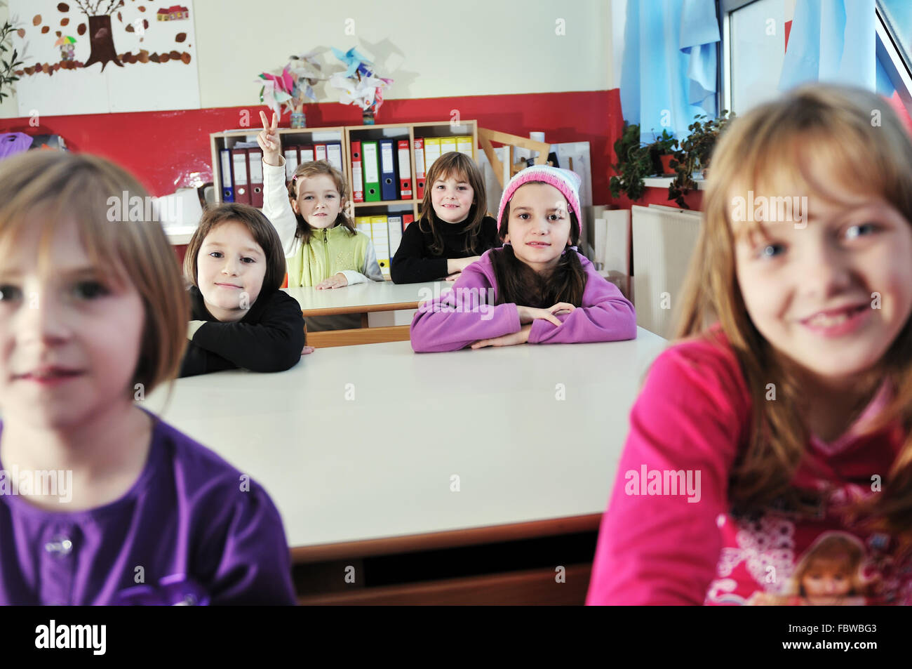 happy kids with teacher in school classroom Stock Photo - Alamy
