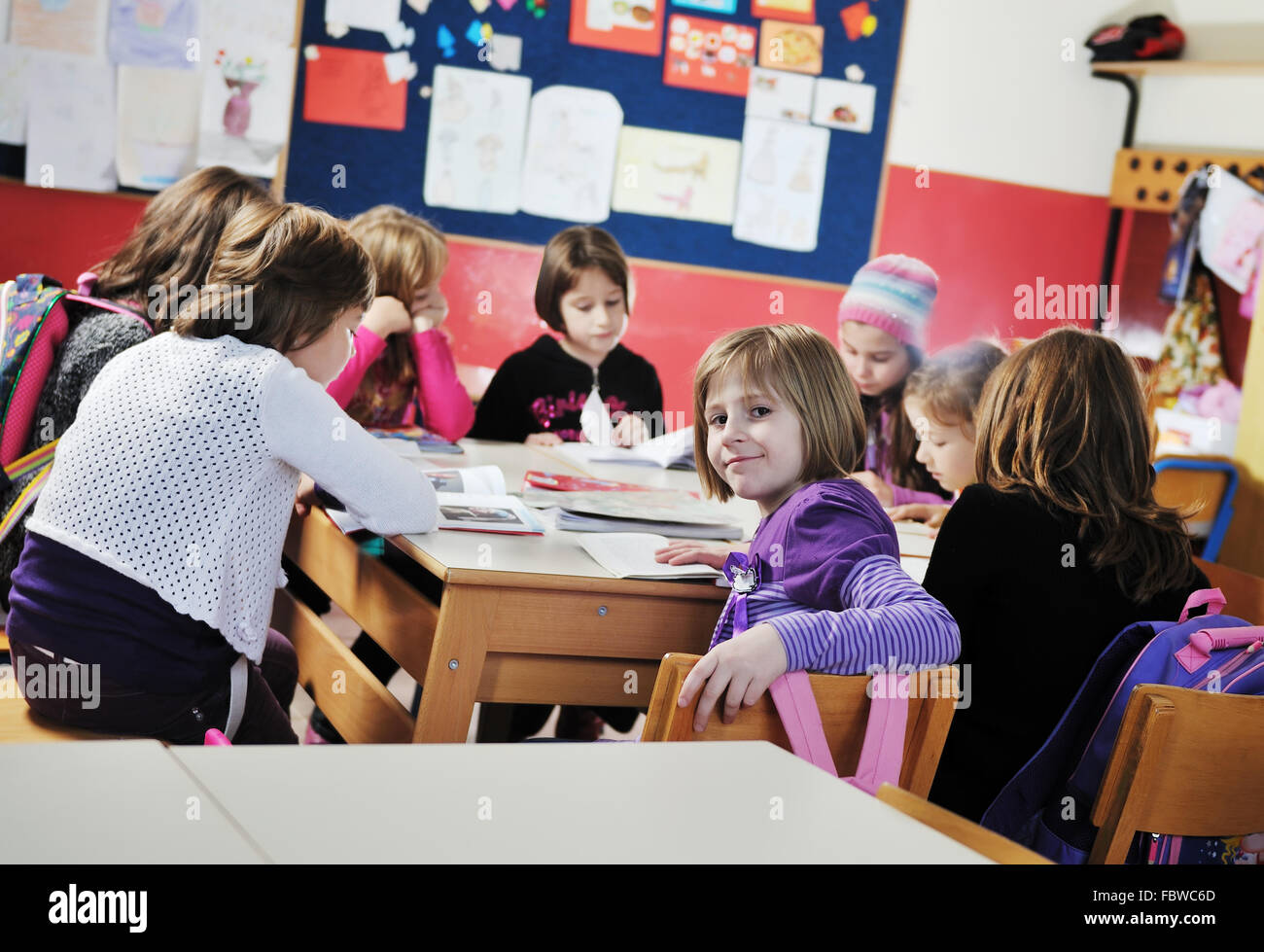 happy kids with teacher in school classroom Stock Photo - Alamy