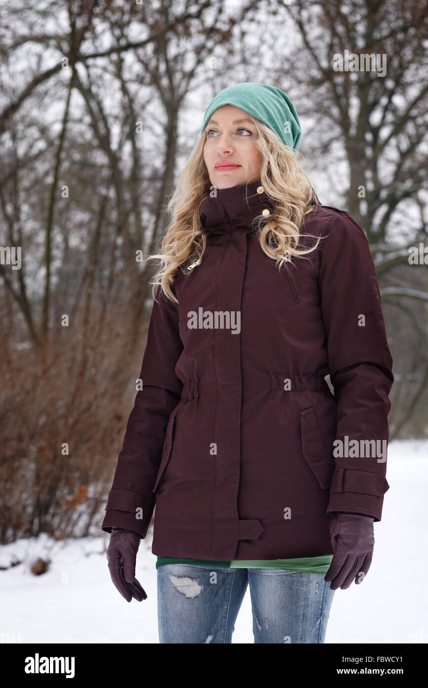 blond woman in snowy forest Stock Photo