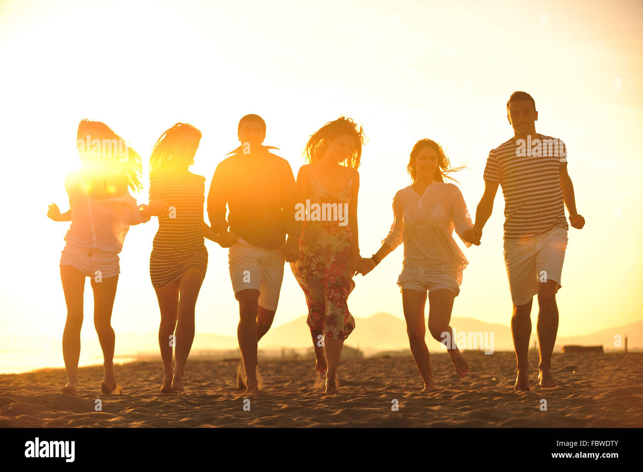 happy young people group have fun on beach Stock Photo - Alamy