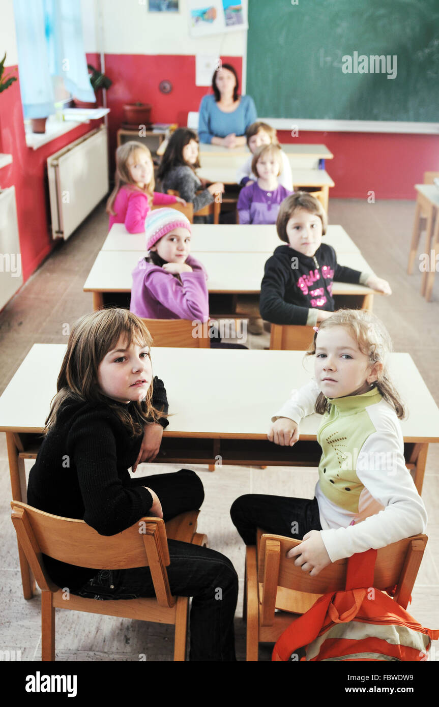 happy kids with teacher in school classroom Stock Photo - Alamy