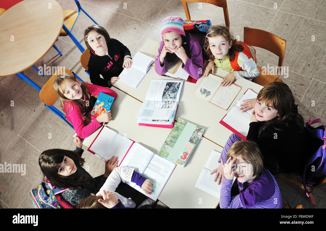 happy kids with teacher in school classroom Stock Photo - Alamy