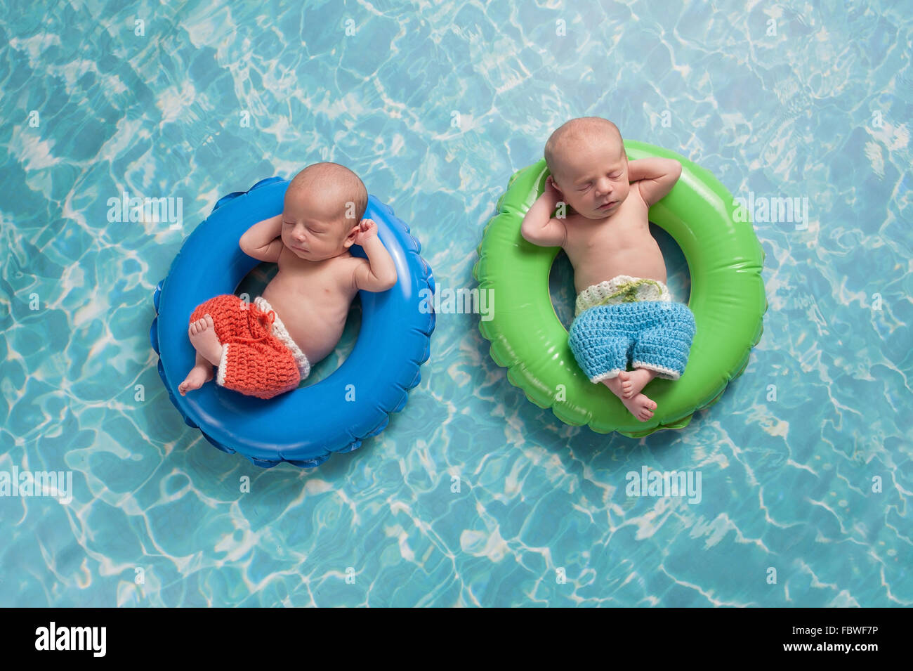 Twin Baby Boys Floating on Swim Rings Stock Photo Alamy