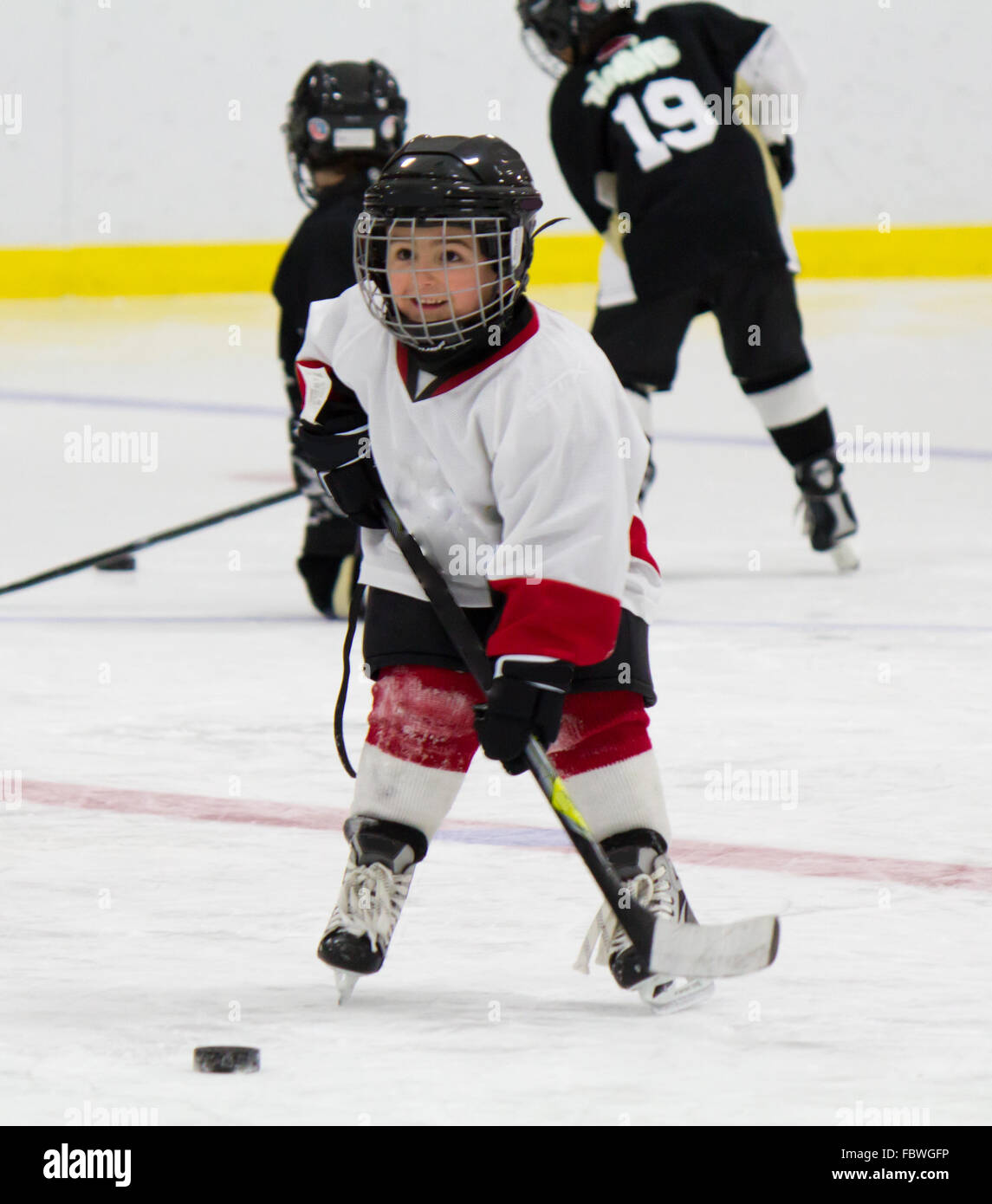 Little boy playing ice hockey Stock Photo Alamy