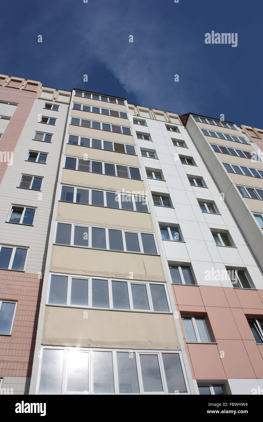 The inhabited high house against the blue sky Stock Photo - Alamy