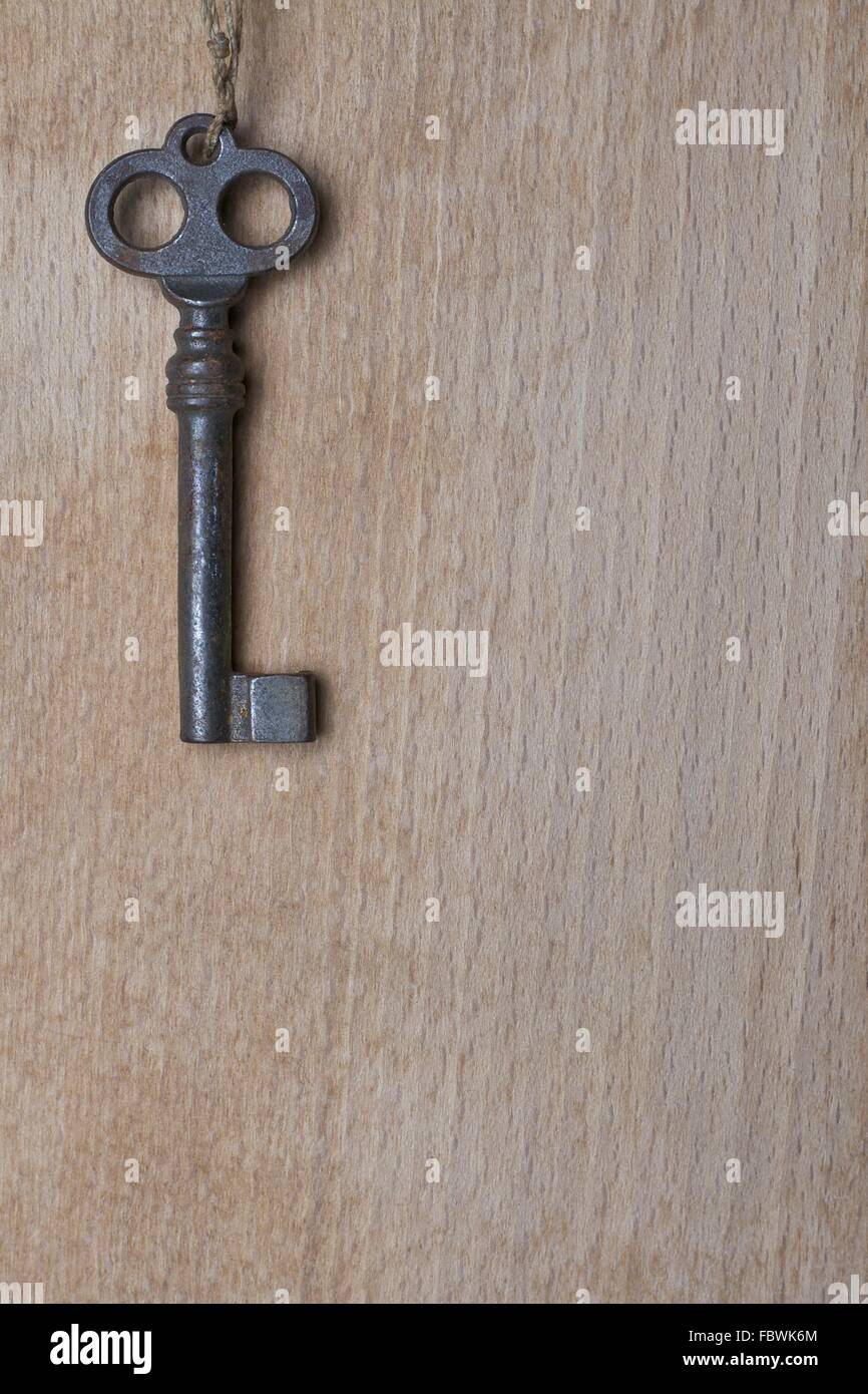 Old Key on a Wooden Surface Stock Photo