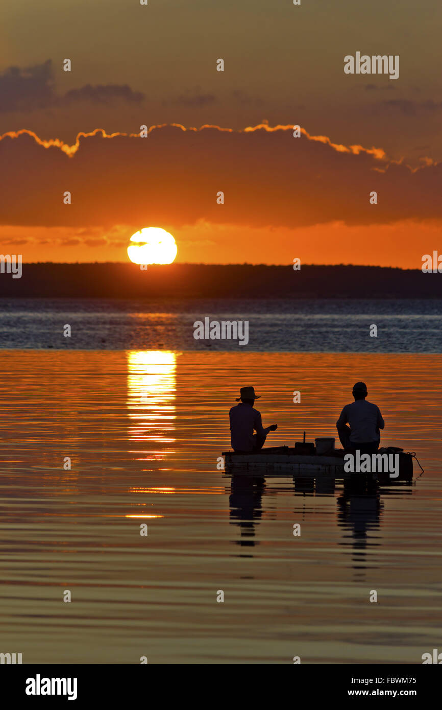 Fishermen in the sunset Stock Photo - Alamy