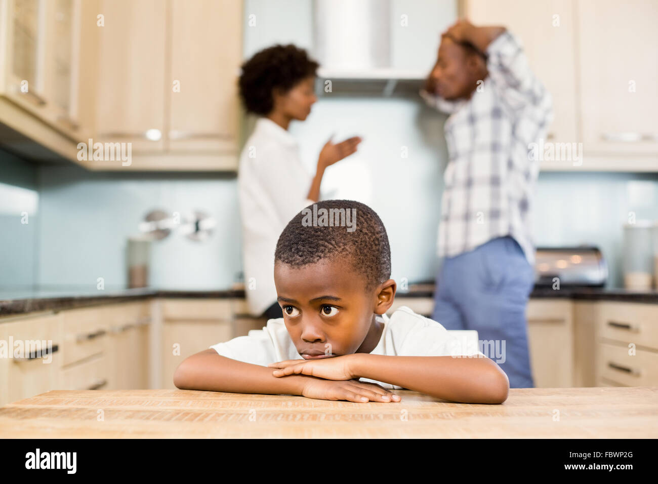 Sad boy against parents arguing Stock Photo