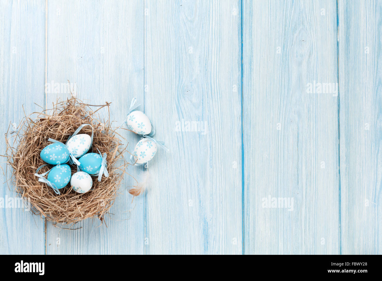 Easter background with eggs in nest over wood. Top view with copy space ...