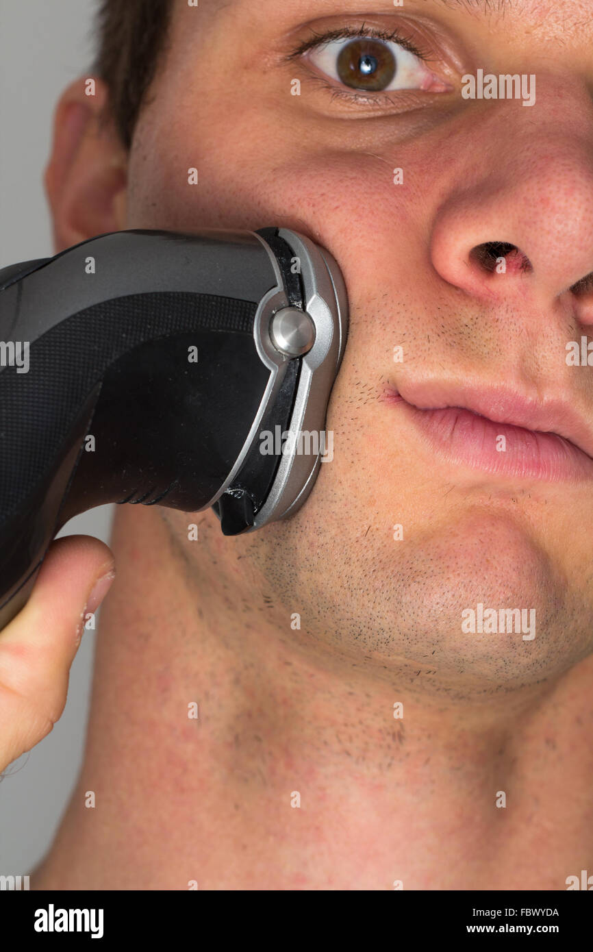 Man shaving face with electric razor Stock Photo Alamy