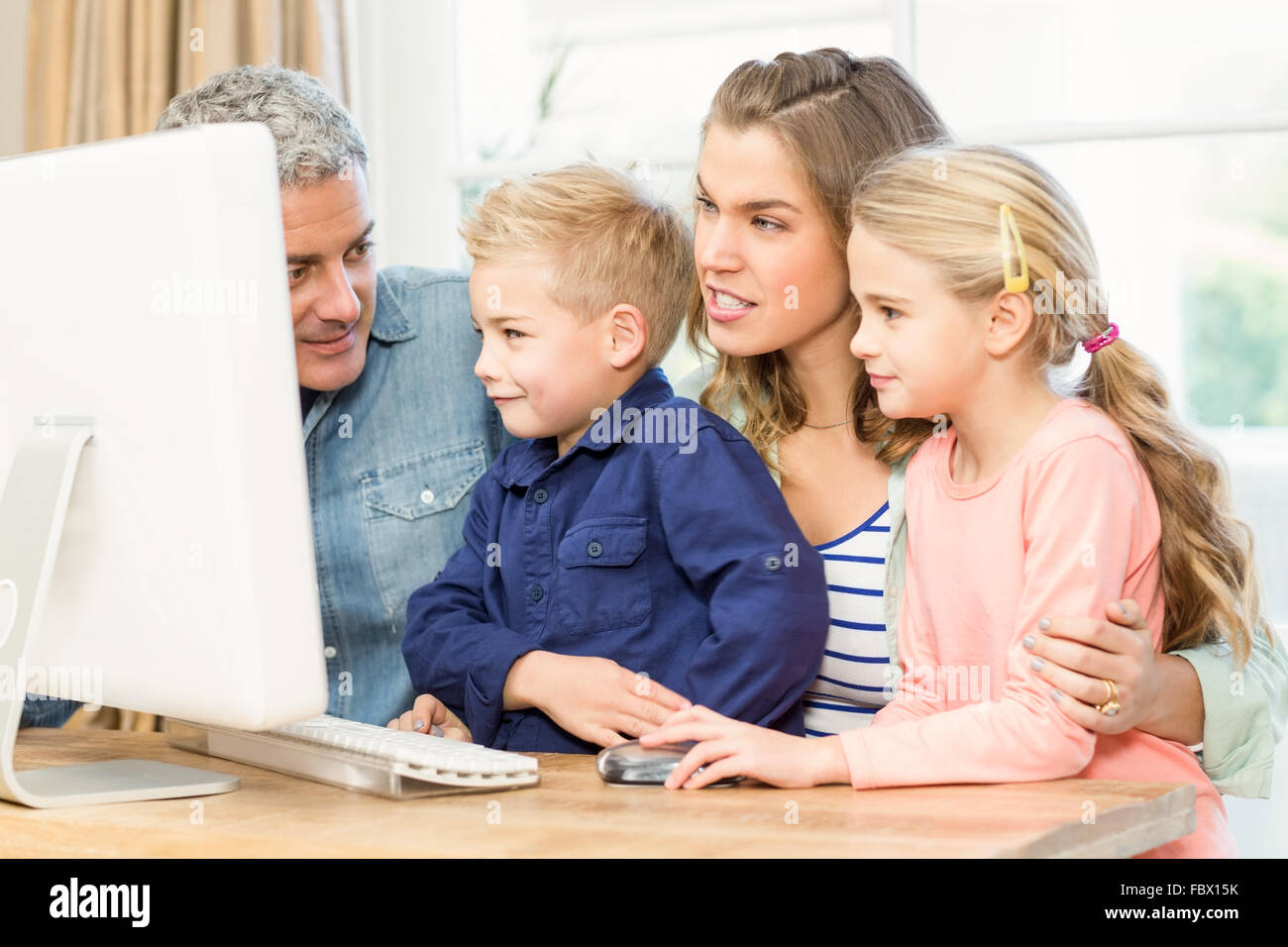 Happy family using the computer Stock Photo - Alamy