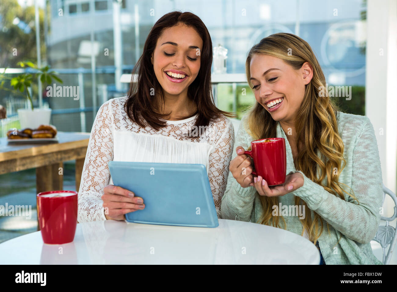 Two girls use a tablet Stock Photo