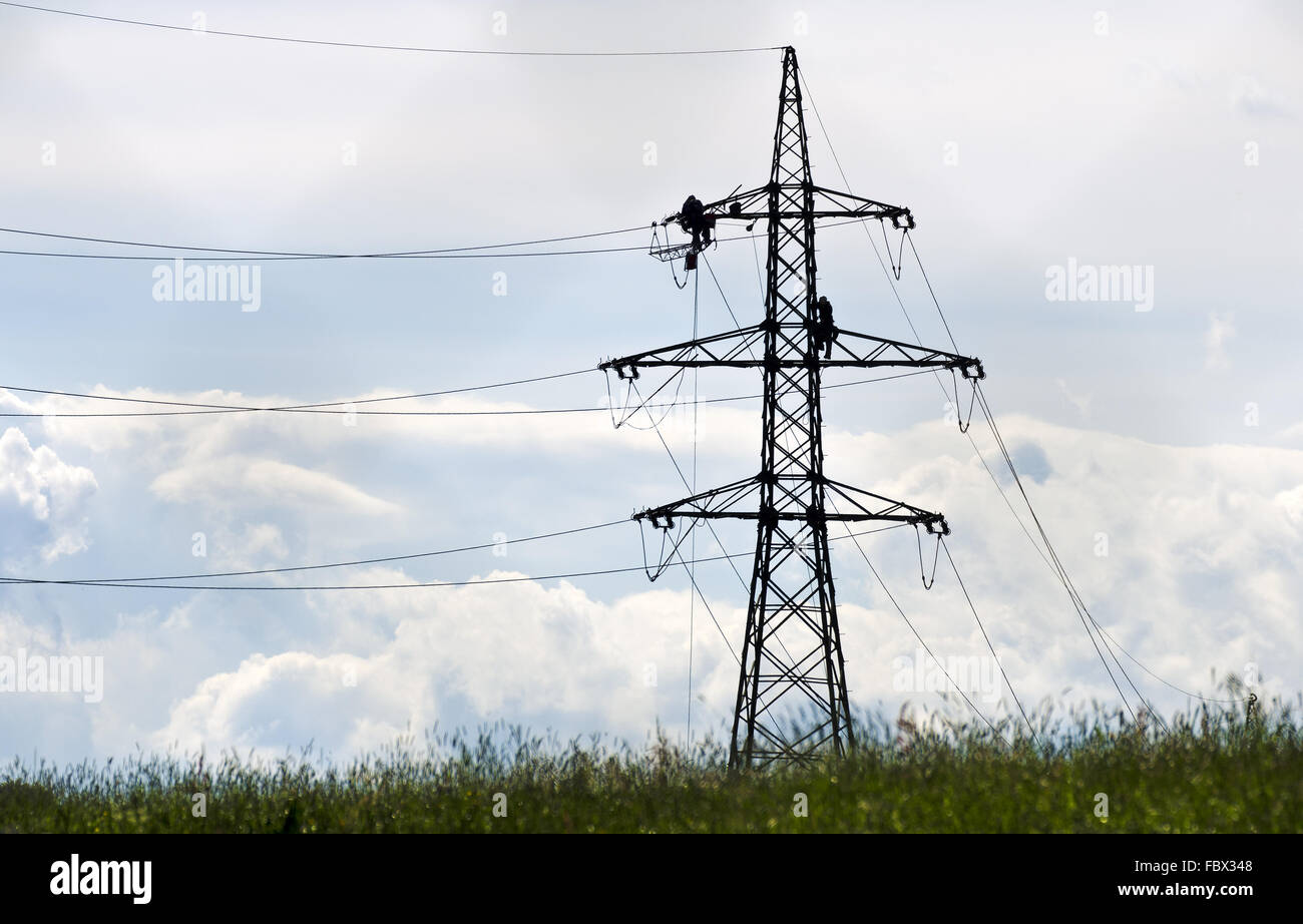 technicians on an electricity pylon Stock Photo