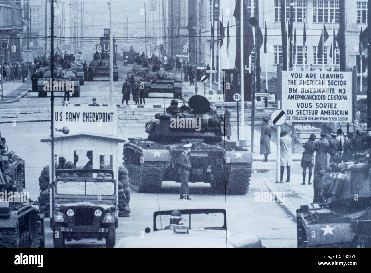 Historic image of Checkpoint Charlie which is part of a large outdoor display close to the famous landmark in Berlin, Germany Stock Photo