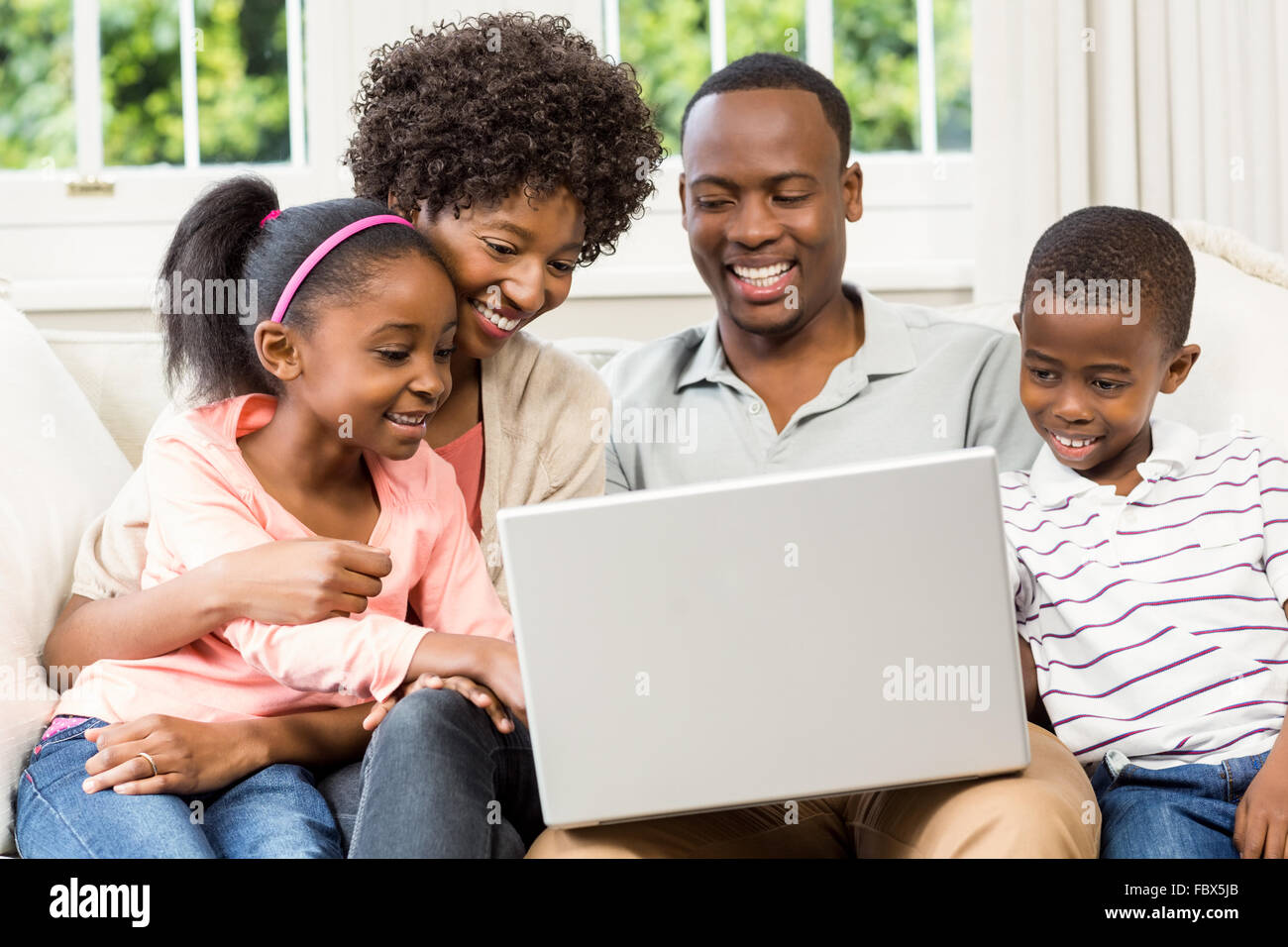 Happy family using laptop Stock Photo - Alamy