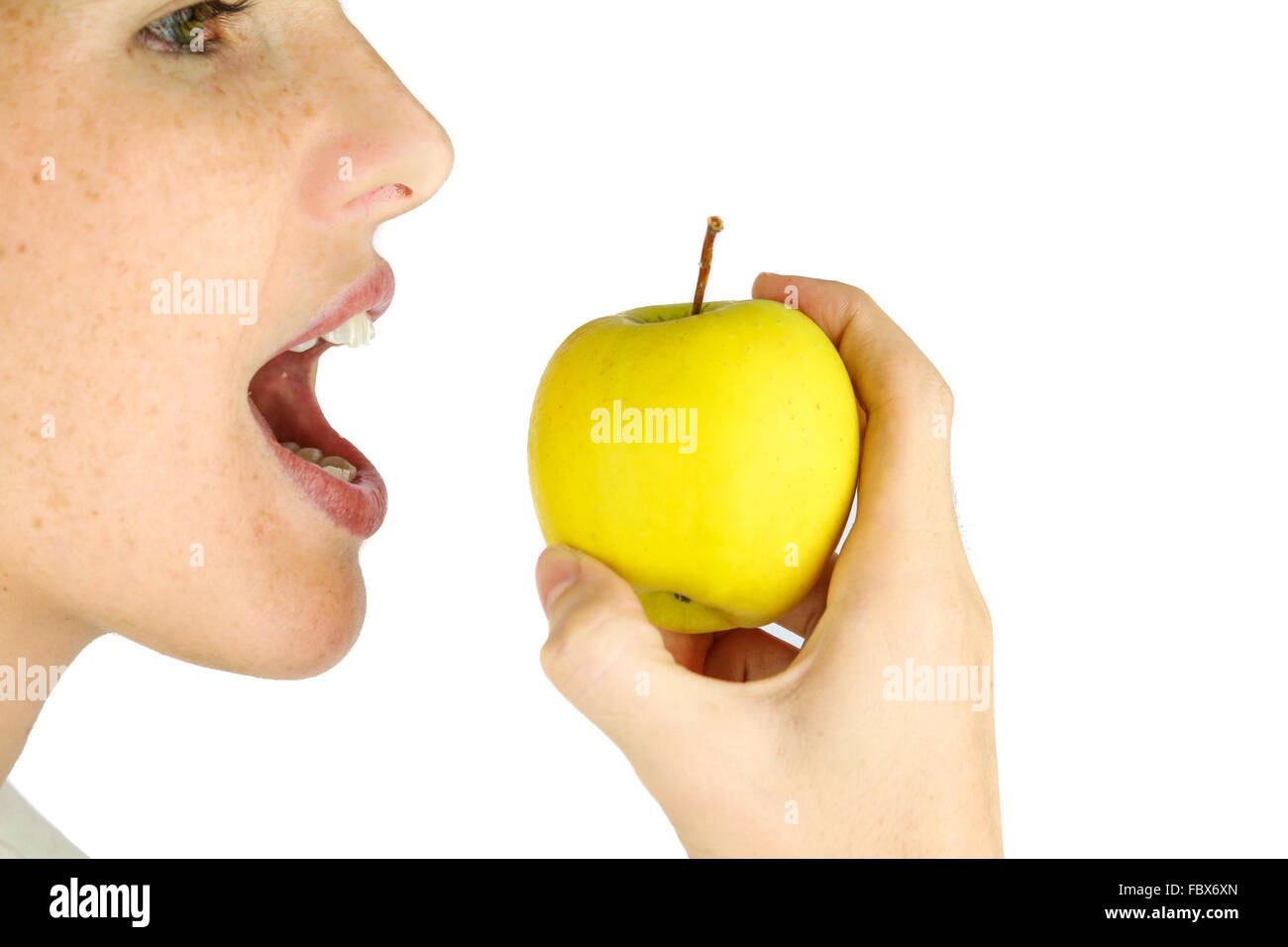 Girl taking a bite of an apple. Stock Photo