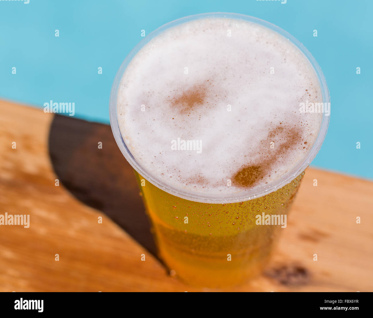Golden lager or beer in disposable plastic cup Stock Photo Alamy
