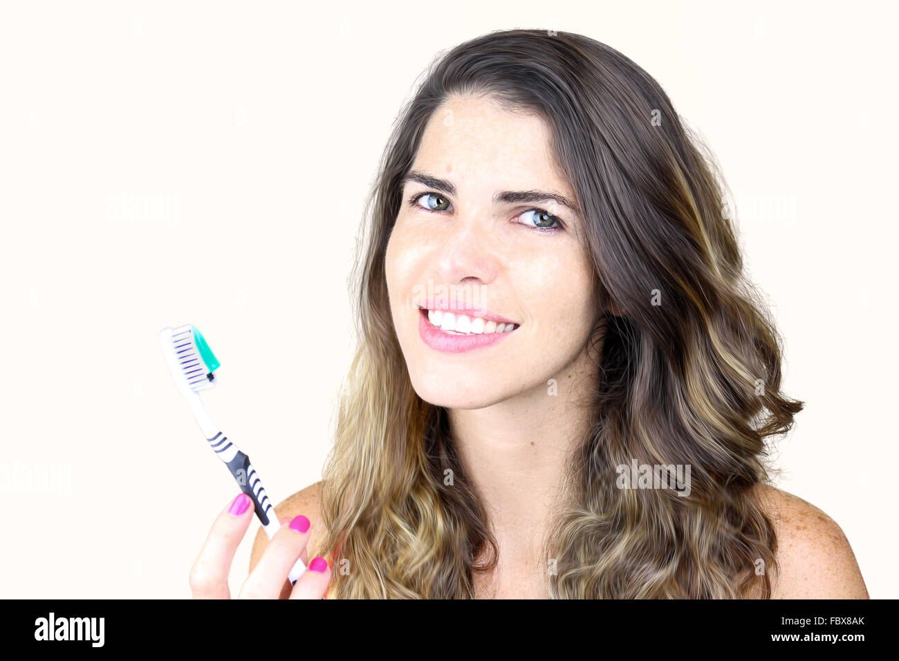Beautiful young lady holding toothbrush and smiling Stock Photo