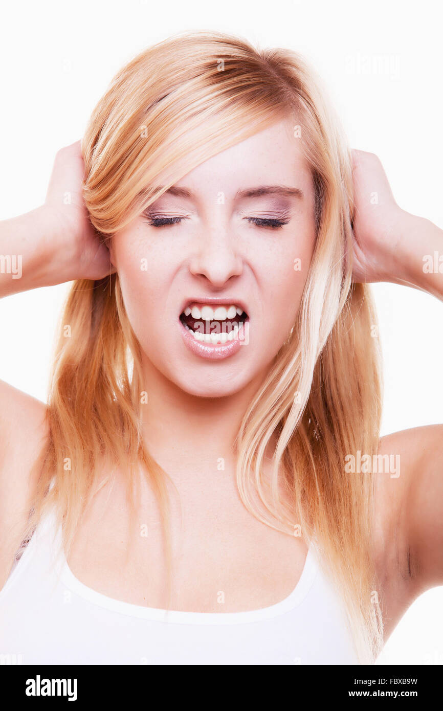 Stress. Young woman frustrated pulling her hair on white Stock Photo